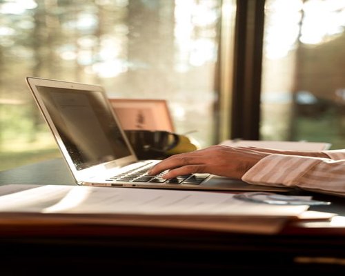 person working on a laptop beside a bright window in Mexico
