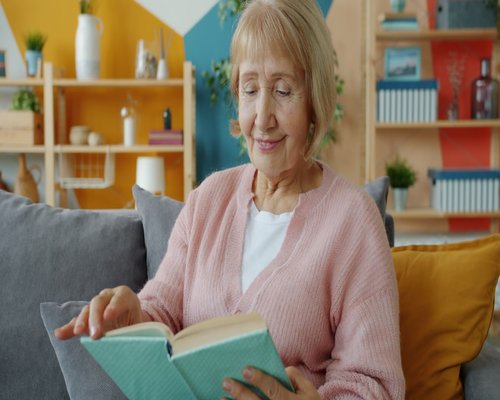 person reading a book in a comfortable room